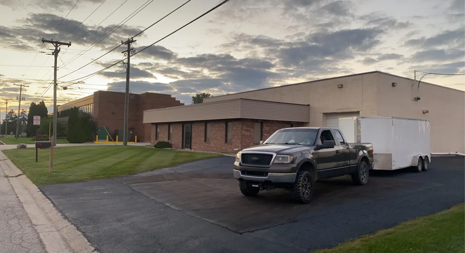 Big Dawgs Lawn & Landscape truck and enclosed trailer at the end of a work day